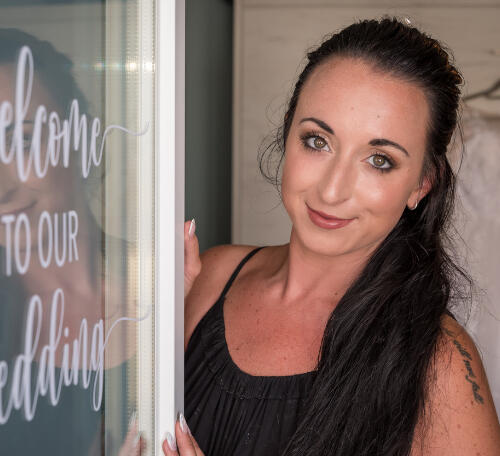 A lady posing for a photo to be taken, hair down in Milos Greece